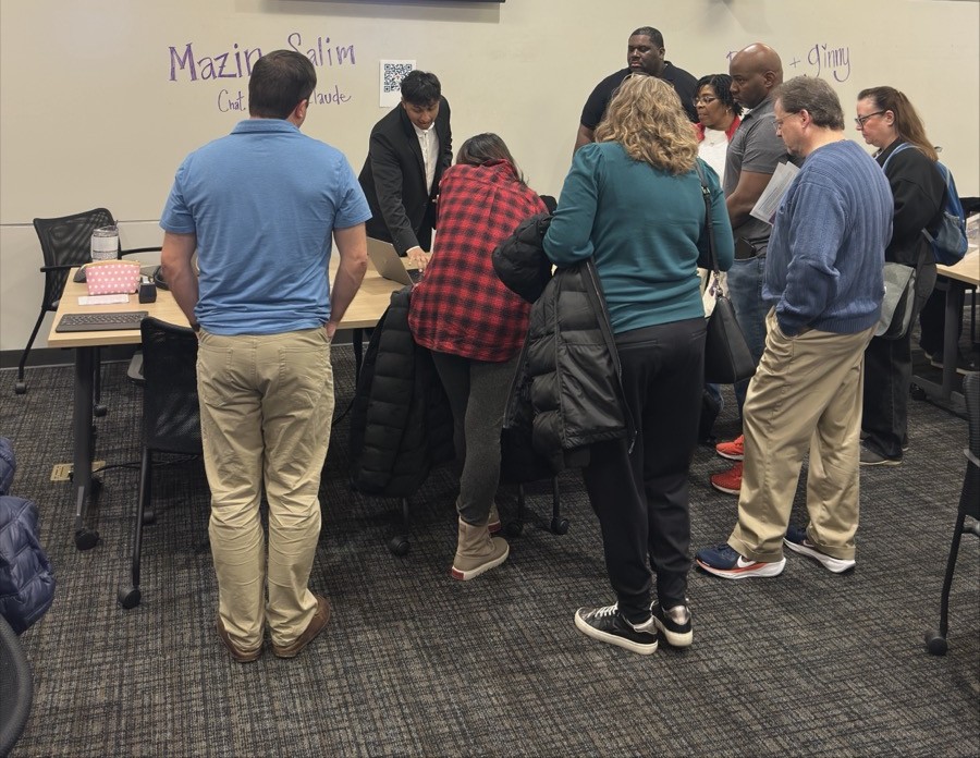 Mazin at the AI Open House guiding attendees through ChatGPT and Claude